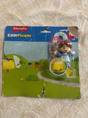 Fisher-Price Little People produce stand worker in packaging